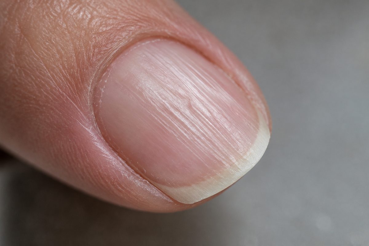 Close-up of clean natural nail plate showing keratin surface texture prior to preparation